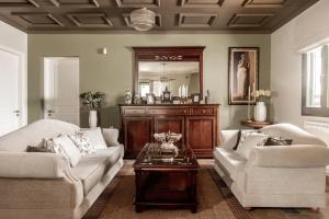 a living room with two couches and a coffee table at Amalthia Villa in Mouzákion