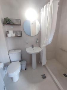 a bathroom with a toilet and a sink and a mirror at Sivotahomes-family in Sivota