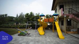 a playground with a yellow slide at Royal Retreat - 7BHK Luxury Villa with Turf in Lonavala
