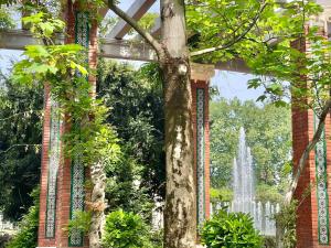 a garden with a fountain in the background at Hotel Lidar in Bilbao