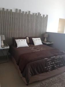 a bedroom with a large bed with two tables at 2 bed 2 bath apartment with stunning sea views. in Ballito