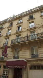 a large building with windows and balconies on it at Hotel Phenix Paris in Paris