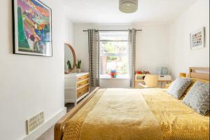a bedroom with a bed and a desk and a window at Bradstone Garden Retreat in Folkestone