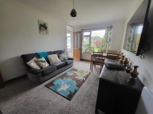 a living room with a couch and a table at A great place for you and your dog to stay in Falmouth