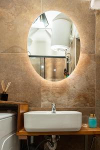 a bathroom with a sink and a mirror at Zoe's apartment in Zakynthos Town