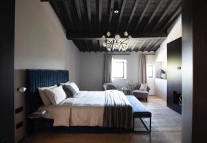 um quarto com uma cama grande e um lustre em PODERE 1384 em Castellina in Chianti