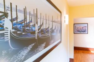 a painting of boats hanging on a wall at Hotel Autoespresso Venice - Atika & Atif in Marghera
