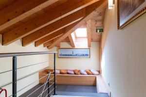 a staircase in a house with wooden ceilings at Hotel Autoespresso Venice - Atika & Atif in Marghera