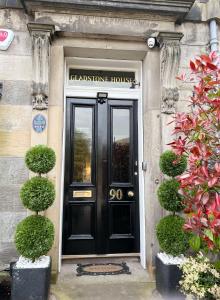 a black door of a house with a sign on it at Gladstone House in Edinburgh