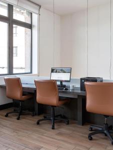 an office with a desk with a computer and chairs at New Hotel of Marseille - Vieux Port in Marseille