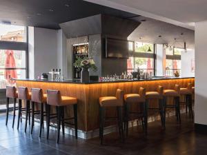 a bar in a restaurant with brown stools at New Hotel of Marseille - Vieux Port in Marseille