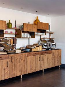 a kitchen with wooden cabinets and utensils at New Hotel of Marseille - Vieux Port in Marseille