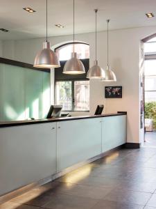 a lobby with a reception desk with two laptops at New Hotel of Marseille - Vieux Port in Marseille