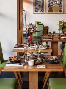 a table with plates of food on it in a restaurant at New Hotel of Marseille - Vieux Port in Marseille