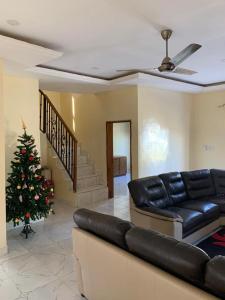 a living room with a couch and a christmas tree at Marie's residence in Medina Suware Kunda