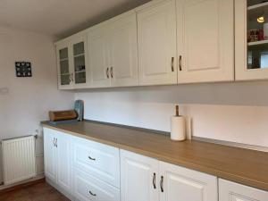 a kitchen with white cabinets and a paper towel at Casa Veronica in Sibiu +32 photos