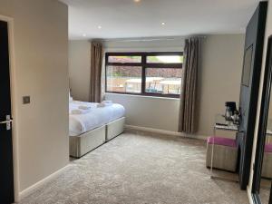 a bedroom with a bed and a window at Hunley Golf Club in Saltburn-by-the-Sea
