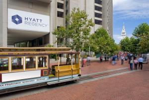 a trolley car on a street in a city at Hyatt Regency San Francisco in San Francisco