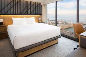 a hotel room with a bed and a large window at Hyatt Regency San Francisco in San Francisco