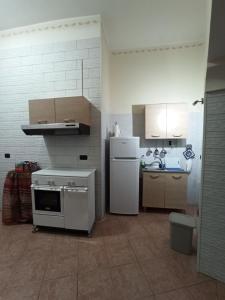 a kitchen with a white stove and a refrigerator at Meraviglie Salentine in Lequile +40 photos