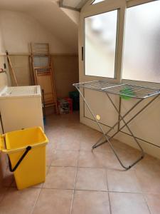 a kitchen with a window and a tiled floor at Meraviglie Salentine in Lequile