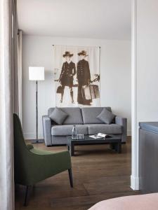a living room with a couch and a table at New Hotel of Marseille - Vieux Port in Marseille