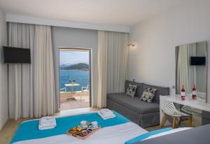 a hotel room with a bed and a couch at Balos Beach in Kissamos