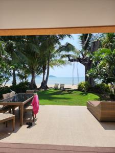 a patio with a view of the beach from a house at Siam Sunset Beach Villas in Ko Chang