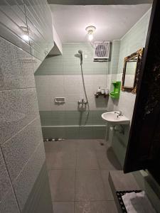 a bathroom with a shower and a sink at Pondok Damai Sidemen in Sidemen