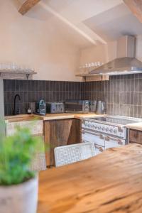 a kitchen with a wooden counter top and a table at Quirky Retreats - The Coach House in Windermere