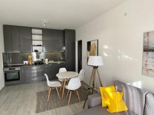 a kitchen with a table and chairs in a room at Infinity Panorama Apartment in Tivat