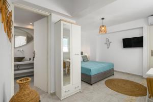 a bedroom with a bed and a bathroom with a mirror at Kapetan Giannis Suite in Adamantas +46 photos