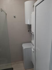 a bathroom with a toilet and a glass shower door at Luxury flat with amazing view INES in Kotor