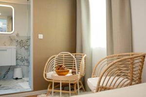 une salle de bain avec deux chaises et une table avec un bol de fruits dessus dans l'établissement New Cute Studioapartment in Ljubljana + Free bikes, à Ljubljana