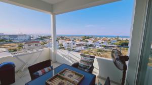a room with a balcony with a laptop on a table at STAY Kapparis View Apartment in Paralimni