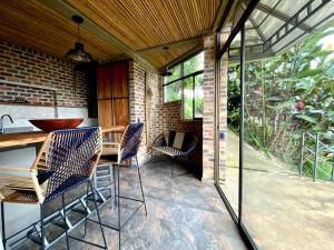 a patio with chairs and a table on a patio at Suite en las Nubes Hotel Portal 360 in Nocaima