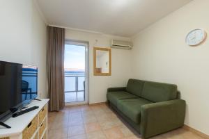 TV a/nebo společenská místnost v ubytování Hotel Rooms Roccia