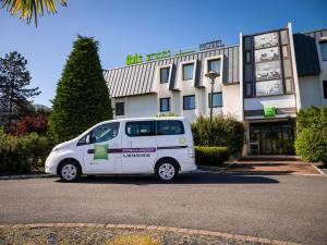 a white van parked in front of a building at ibis Styles Bordeaux A&eacute;roport in M&eacute;rignac