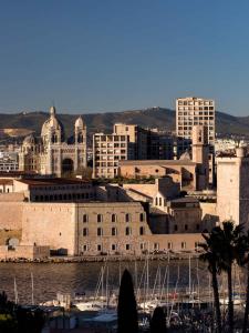 a city with buildings and boats in the water at New Hotel of Marseille - Vieux Port in Marseille