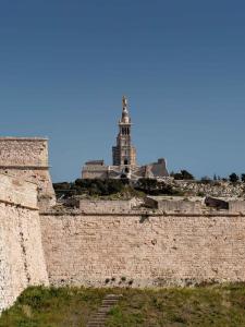 a building on top of a brick wall at New Hotel of Marseille - Vieux Port in Marseille