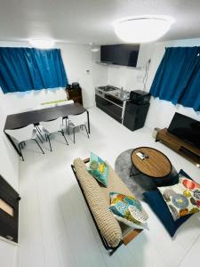 a living room with a couch and a table at COAST西糀谷 in Tokyo