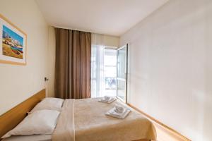 Postel nebo postele na pokoji v ubytování Hotel Rooms Roccia