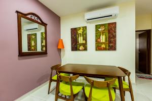a dining room with a wooden table and chairs at HyperTribe -Pangkor Holiday Home in Kampong Sungai Udang