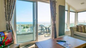 a living room with a view of the ocean at Luxury 3 Bed 2 Bath Lodge with Sea Views! in Exmouth