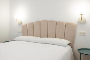 Łóżko lub łóżka w pokoju w obiekcie Oriente Suites