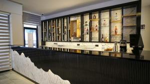 a bar in a room with a wall of books at Ephesus Hitit Hotel restaurant in Selçuk