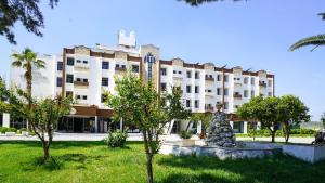 a large white building with a fountain in front of it at Ephesus Hitit Hotel restaurant in Selçuk