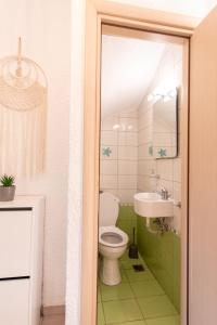 a bathroom with a toilet and a sink at Villa Alex Holiday Home in Kriopigi