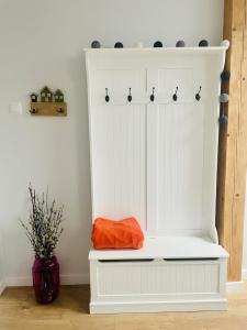 a white closet with an orange bag on it at Zakątek Solny in Bochnia