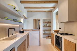 a kitchen with a sink and a stove top oven at Beachfront 3BR Villa Iremia in Naxos in Naxos Chora +40 photos